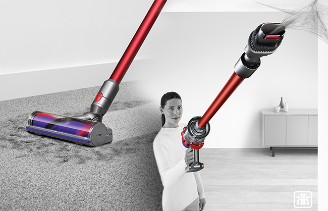 Woman using dyson vacuum on floor and ceiling