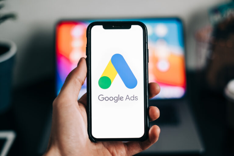 Google Ads logo on smartphone screen in hand.